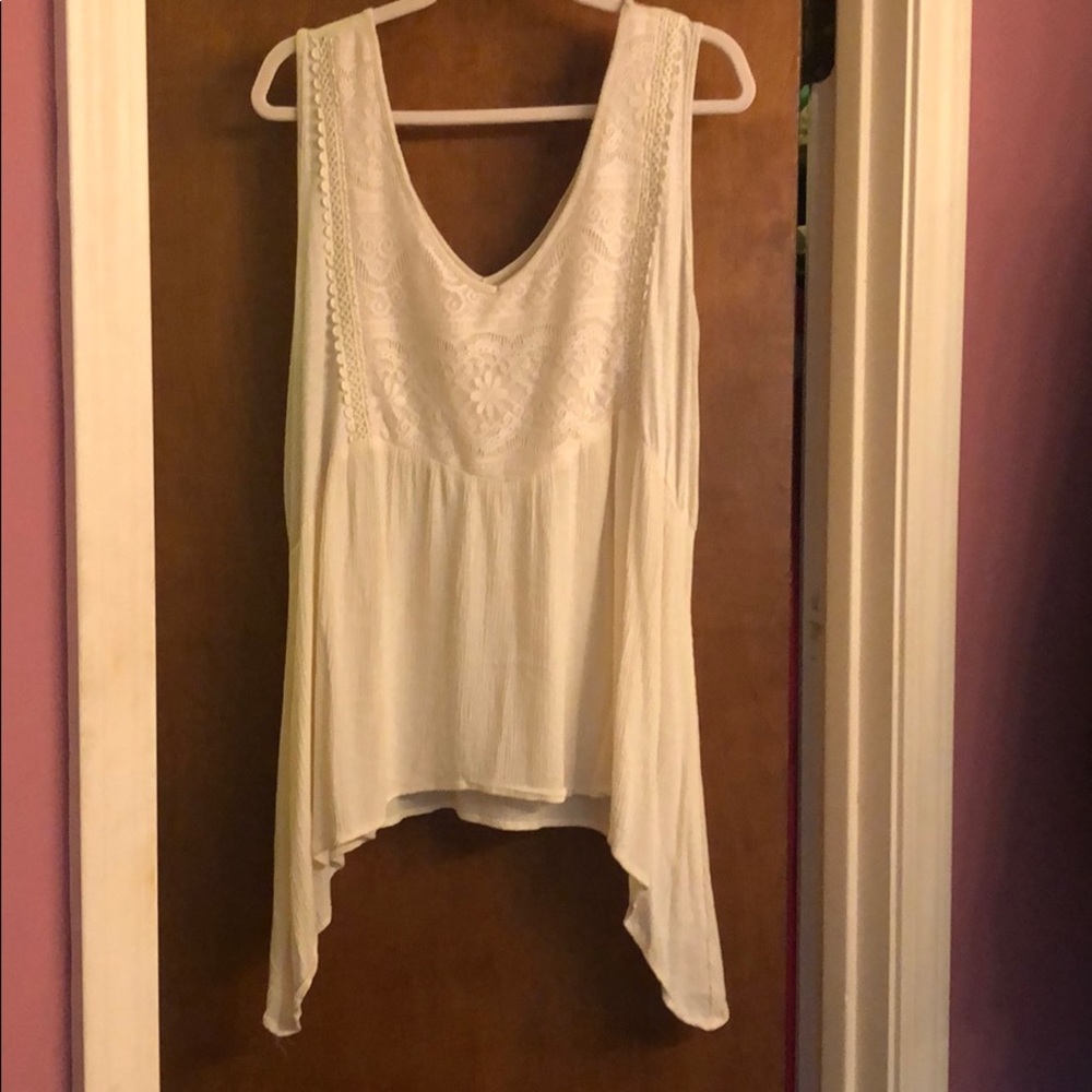 Sleeveless off white,v-neck top with sharkbite hem